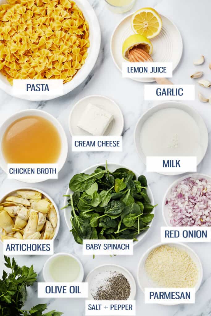 Ingredients for Instant Pot spinach artichoke pasta: pasta, lemon juice, chicken broth, cream cheese, milk, artichokes, baby spinach, red onion, olive oil, salt and pepper, and parmesan cheese.