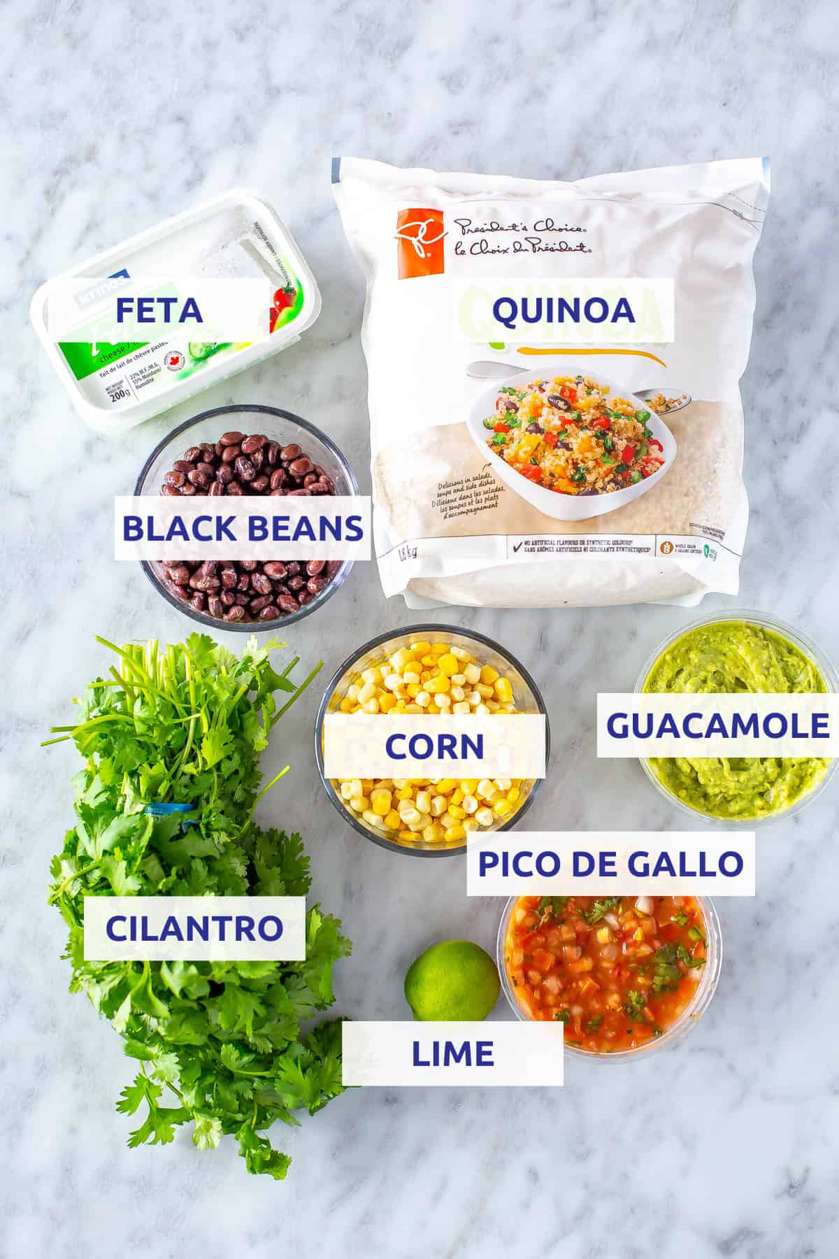 Ingredients for Instant Pot quinoa burrito bowls: quinoa, feta, black beans, corn, cilantro, guacamole, lime and pice de gallo.