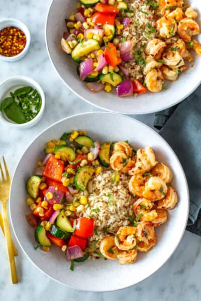 Two bowls of Instant Pot shrimp with rice and veggies.